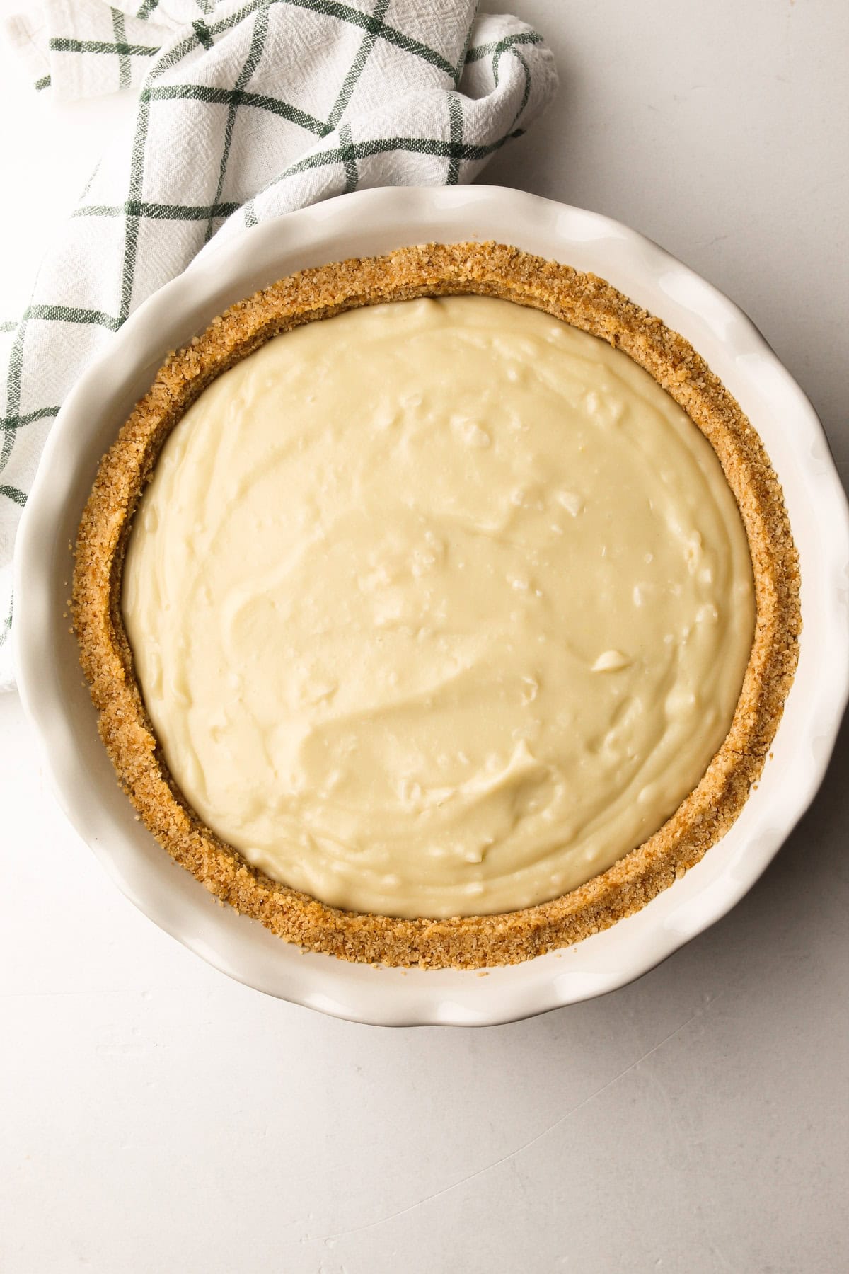 Coconut pudding filling spread evenly into the crust for no-bake coconut cream pie.
