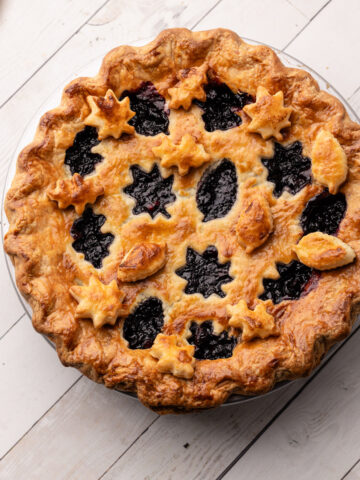 A baked Blueberry-Cranberry Pie with fall leaf cutouts in the crust.