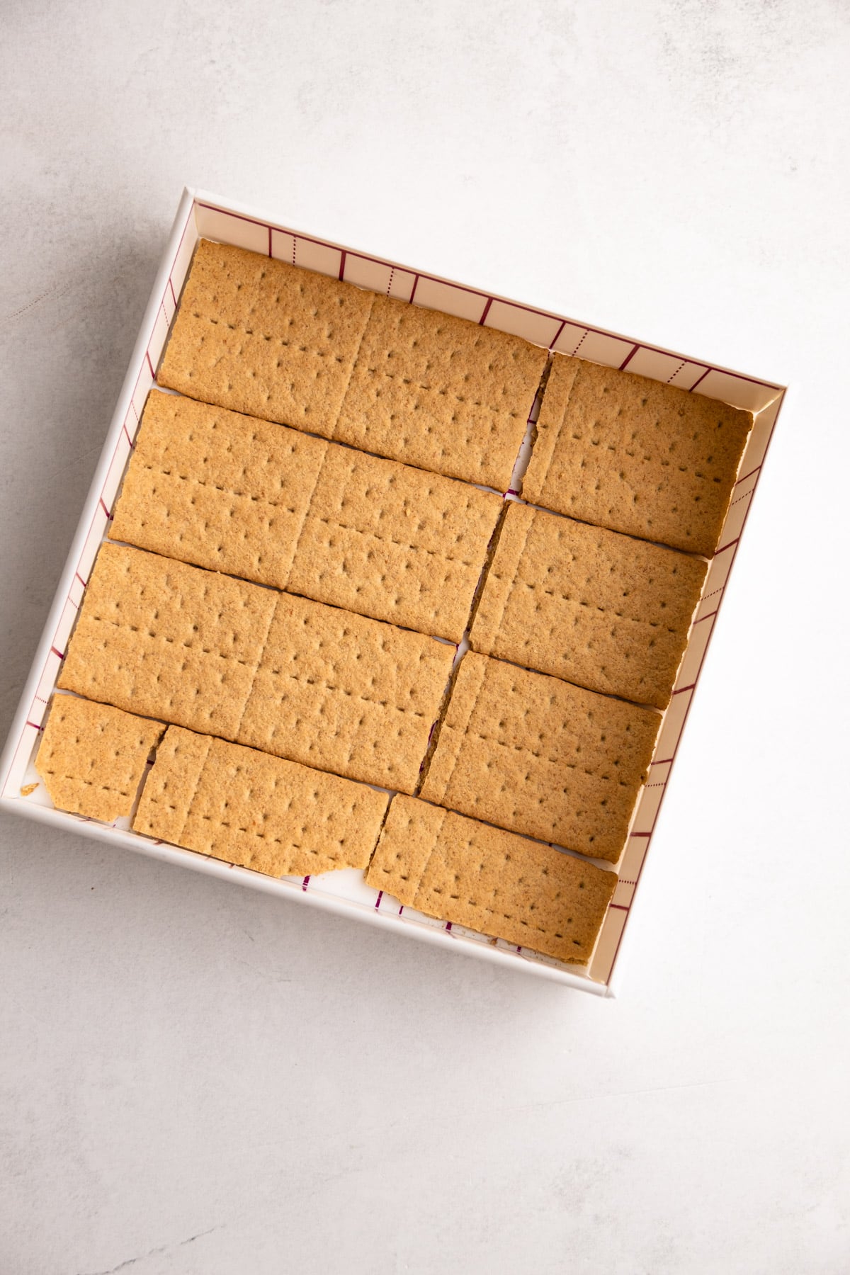 Graham crackers in a tin for an icebox cake.