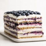 Blueberry Icebox Cake decorated with blueberries and revealed layers.