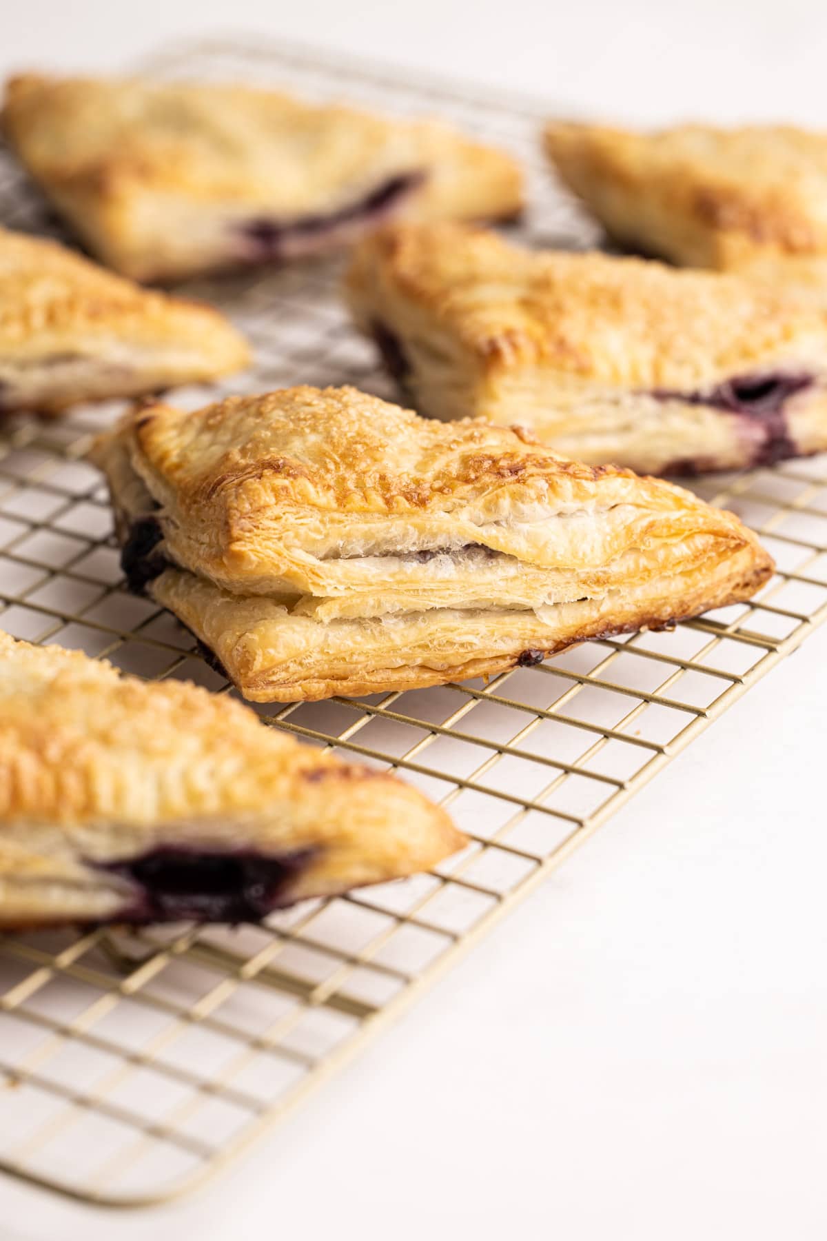 Blueberry turnovers on a cooling rack.