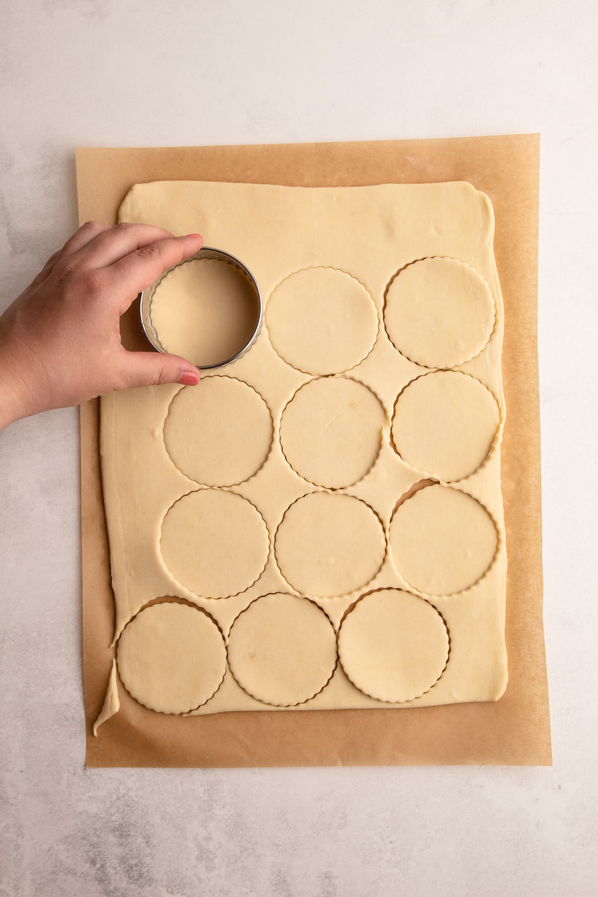 Puff pastry rolled out and stamped with a cutter for tarts.