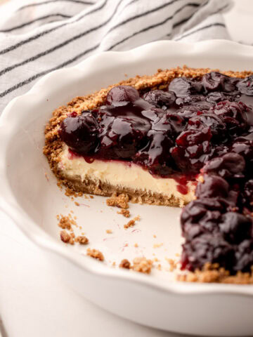 A slice of cherry cheese pie in a crunchy crumb crust.