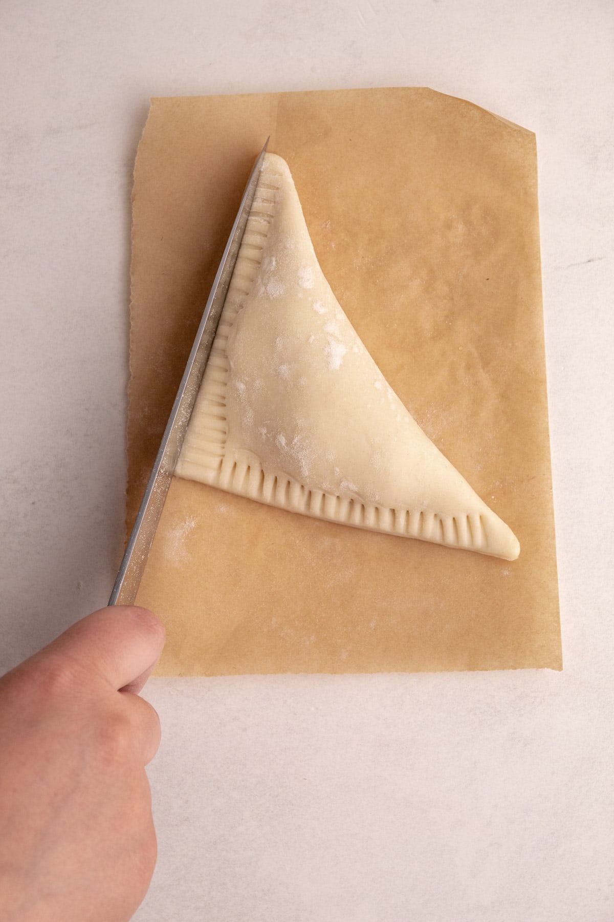 Slicing off the edges of a turnover.