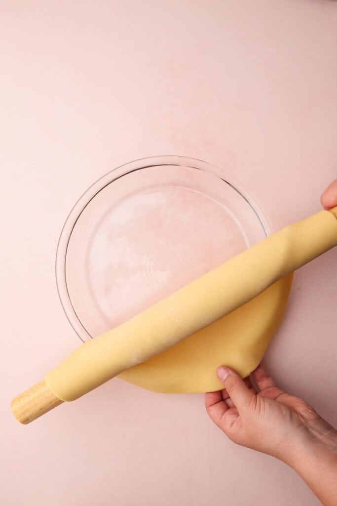 Putting a pie crust in a tin.