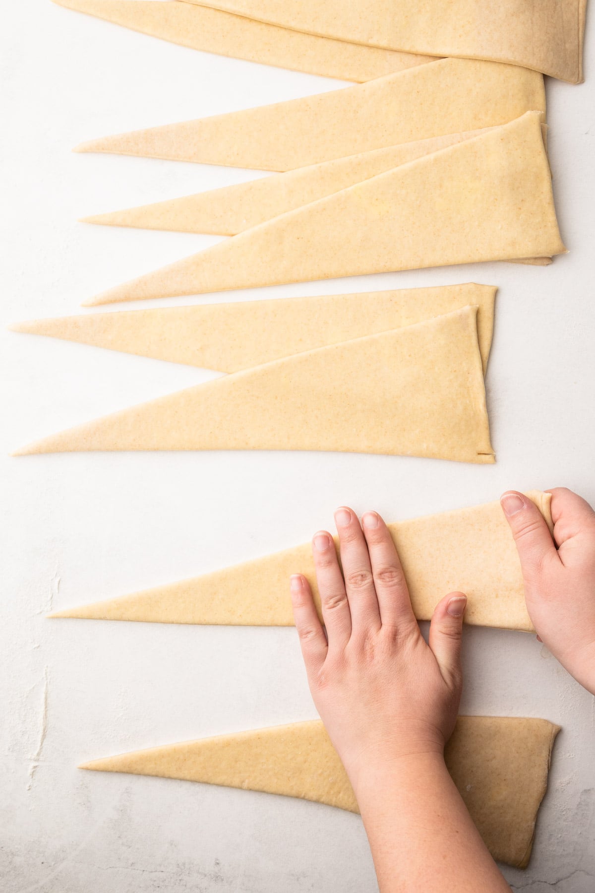 Shaping homemade shortcut croissants.