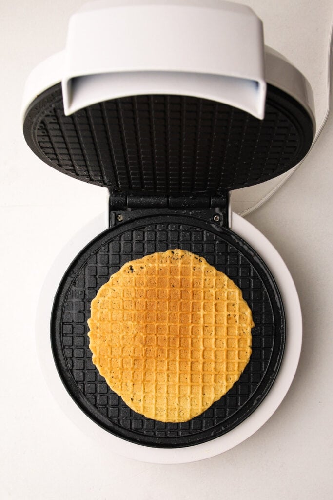 Cooking waffle cones on a waffle cone maker.