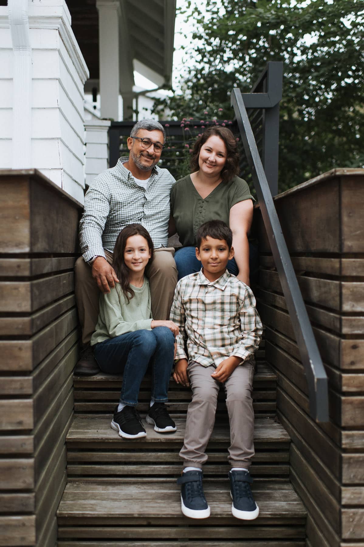 Kelli Avila, creator of Everyday Pie, sitting with her family on front porch steps.