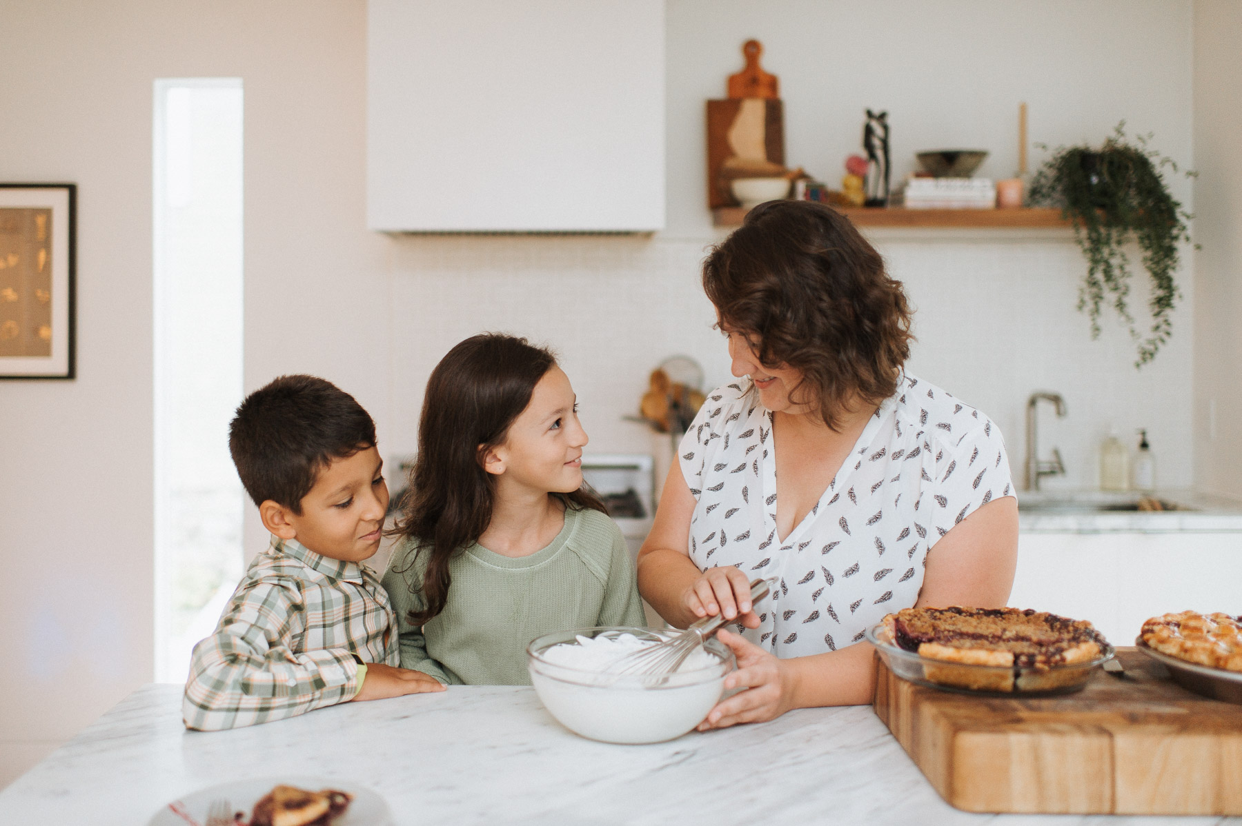 Kelli Avila in a kitchen with her kids.