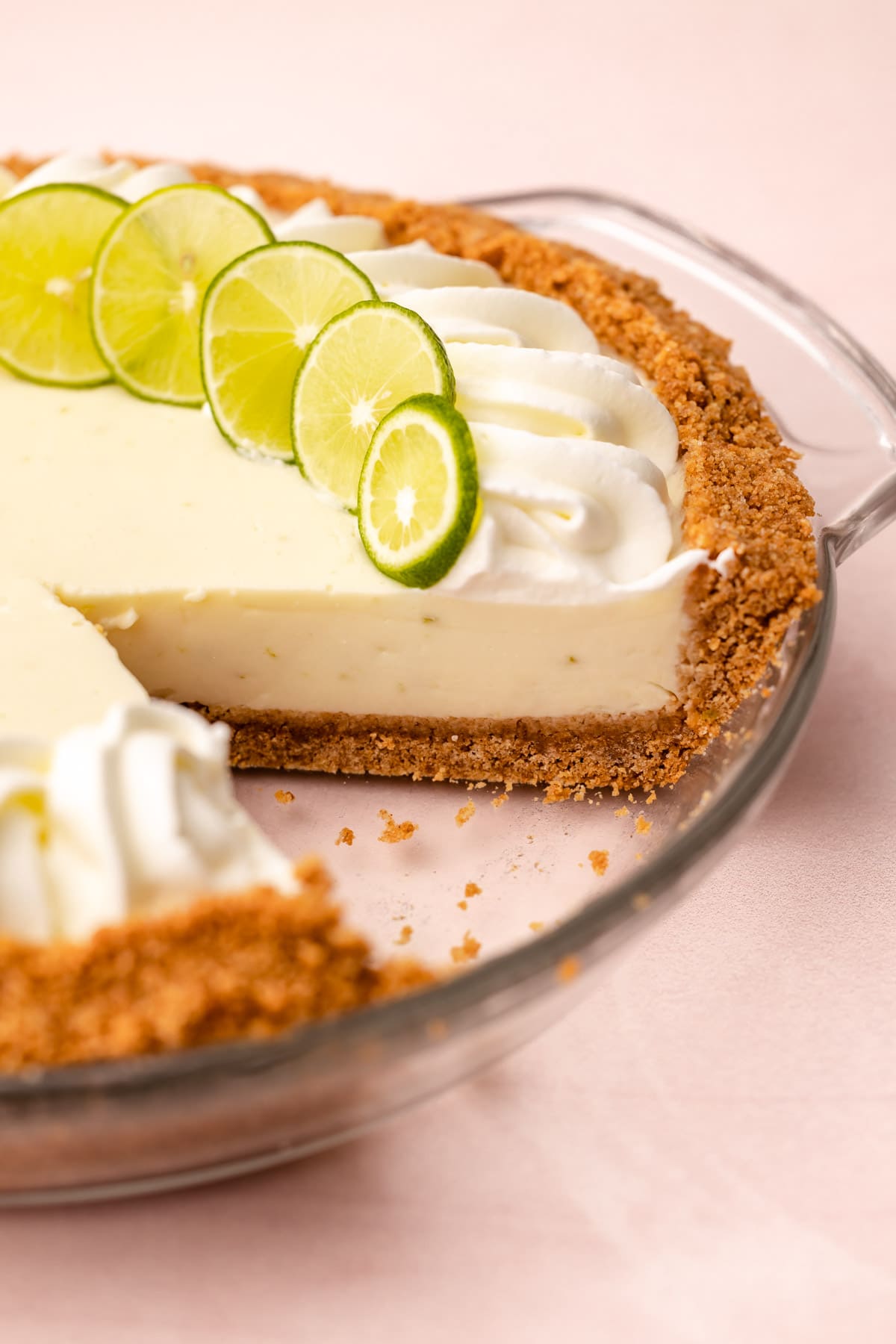 A key lime pie with whipped cream on top.