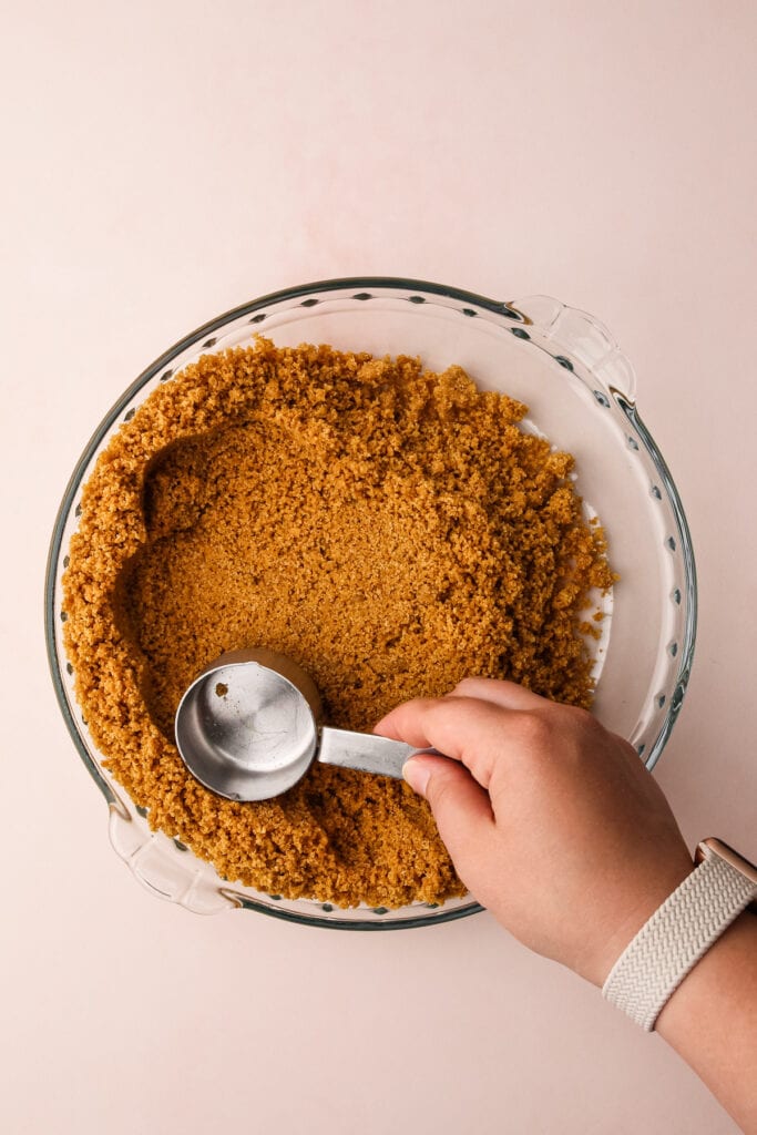 Making a graham cracker pie crust.