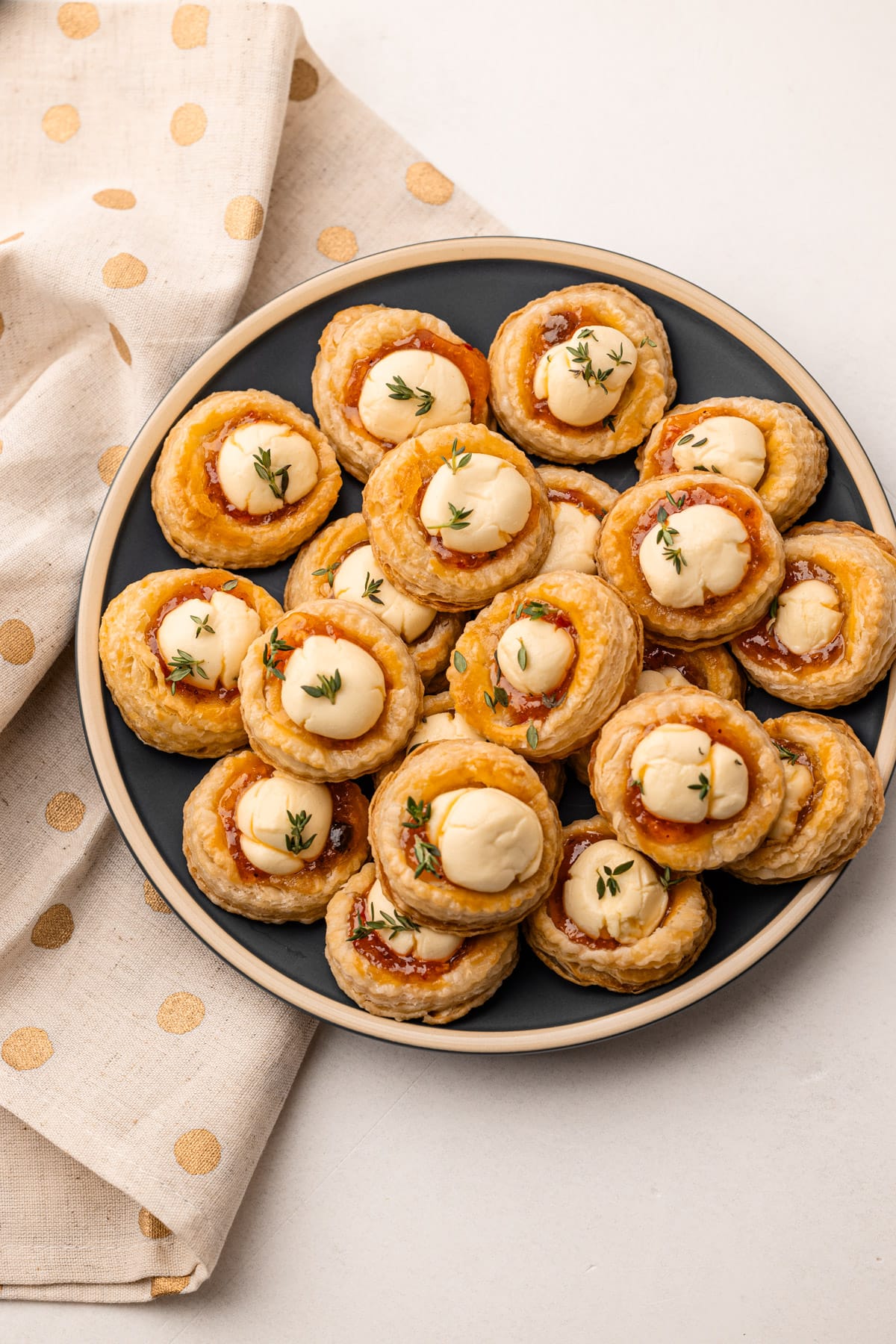 Baked cream cheese and pepper jelly bites on a plate.