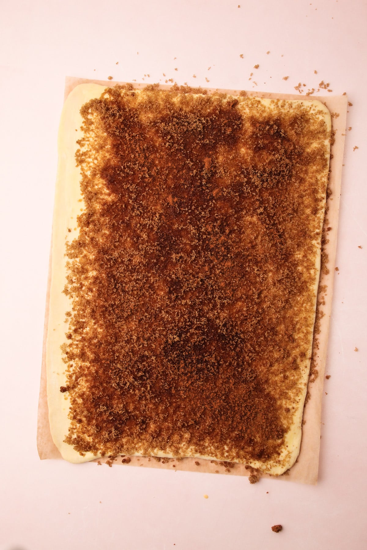 A sheet of puff pastry covered with cinnamon filling for puff pastry cinnamon rolls.