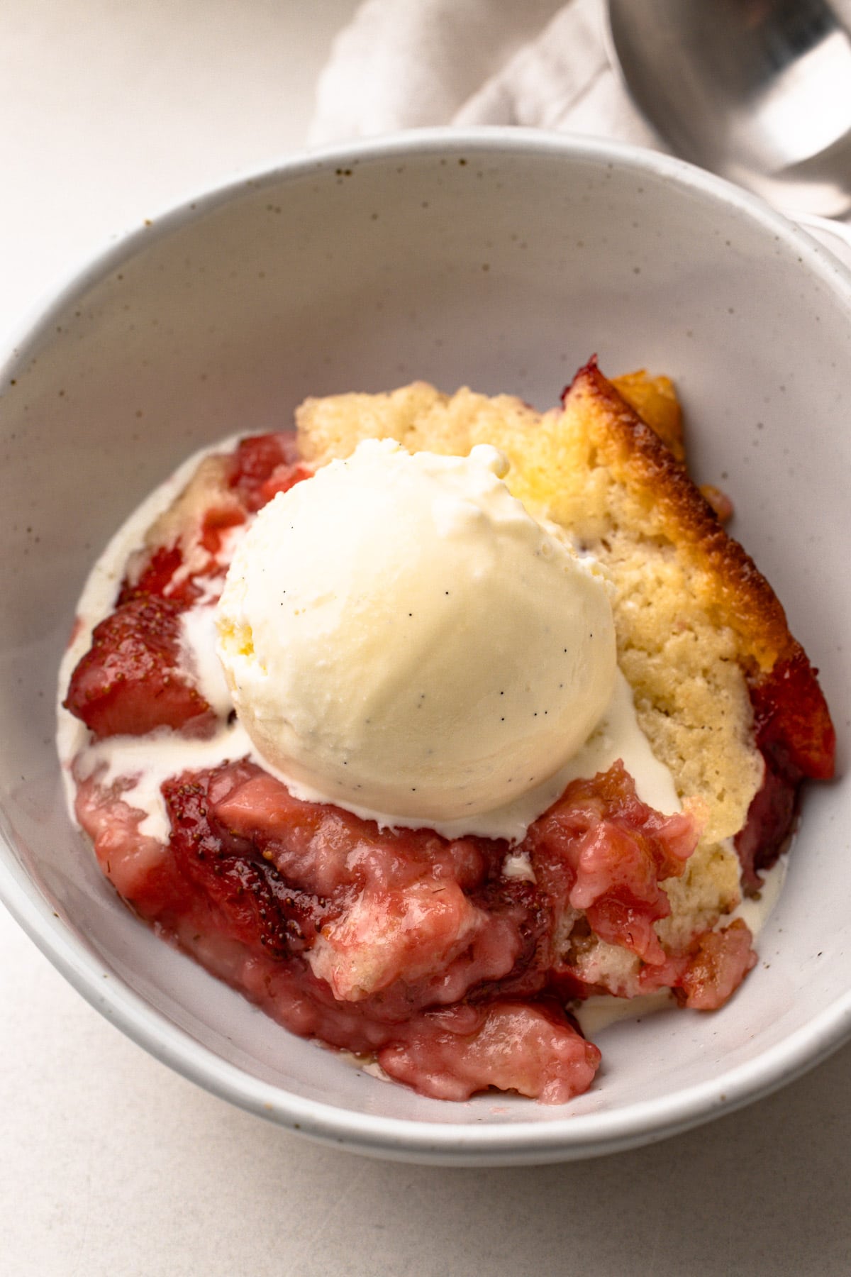Strawberry cobbler with vanilla ice cream.
