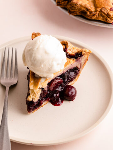 A slice of sweet cherry pie made with frozen cherries.